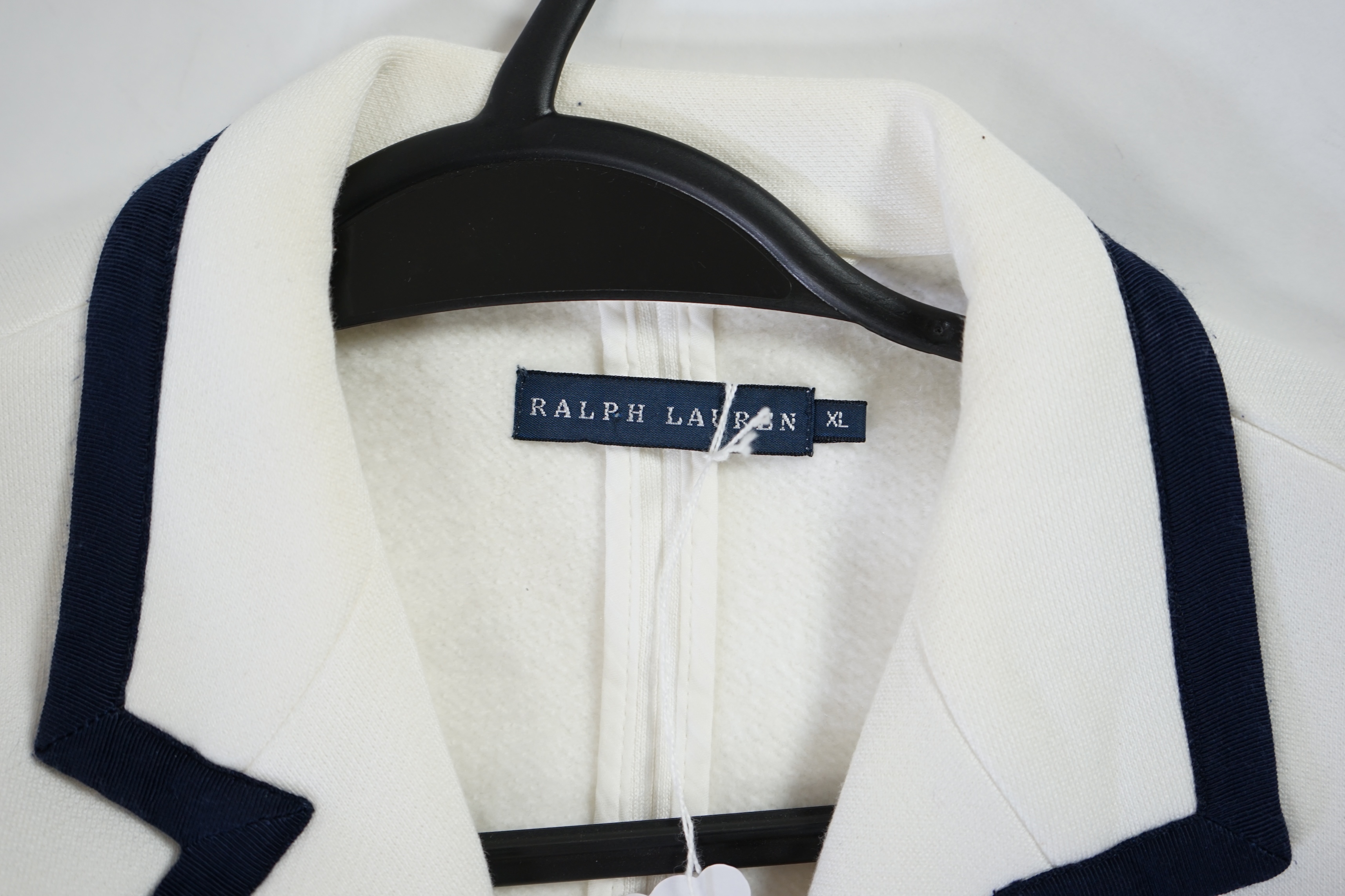 A cream Ralph Lauren blazer with navy blue cord piping. Proceeds to Happy Paws Puppy Rescue